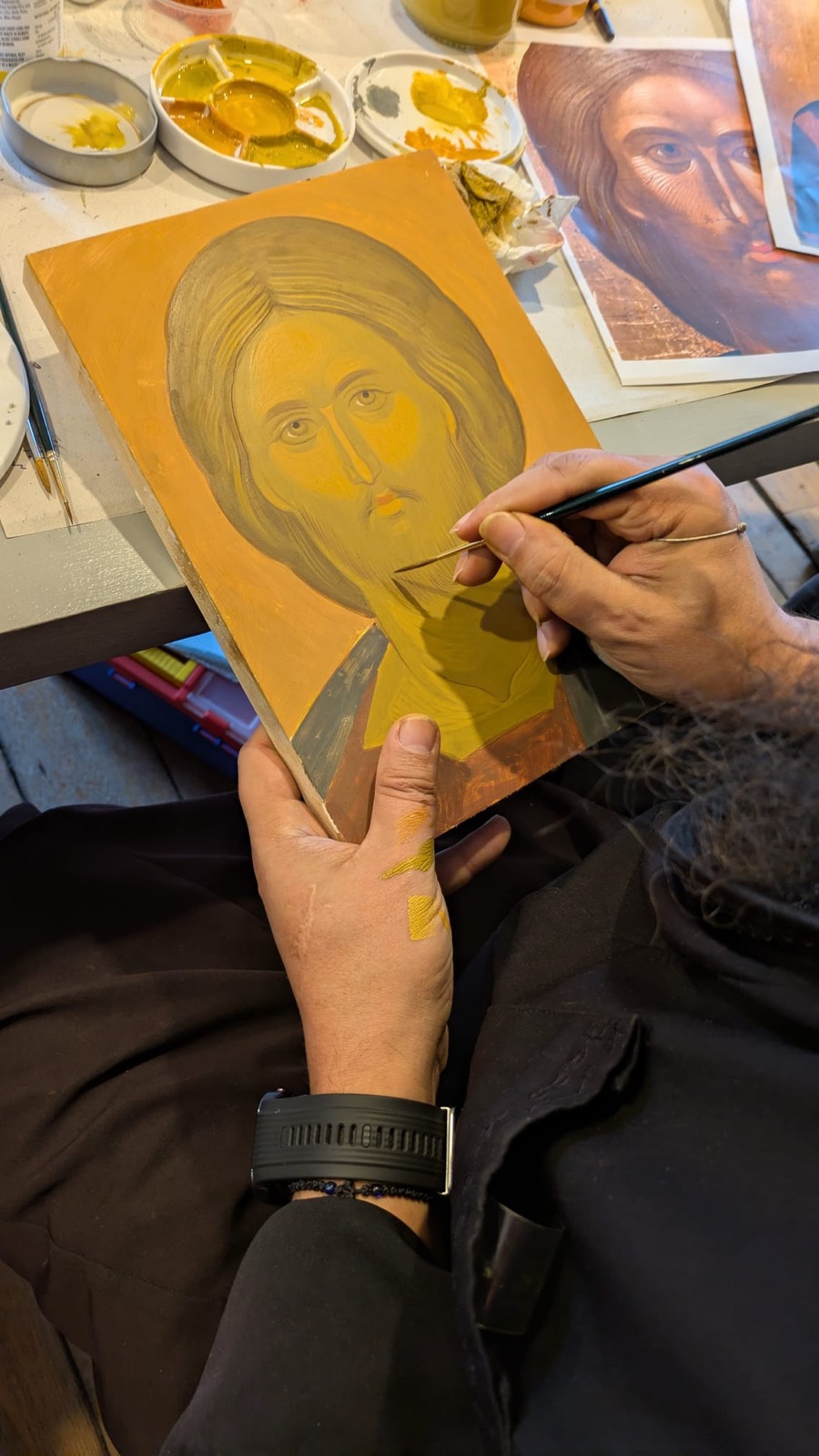 Father Ilie painting the face of the Pantocrator icon